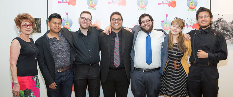 Andrea Thomas, Forgotten Song Foundation Scholarship Director, stands with scholarship recipients: Jeymar Perez Mendoza, Michael Gigante, Jason Vazquez, Peter Goomroyan, Amy Crosley, and Jake Macias.