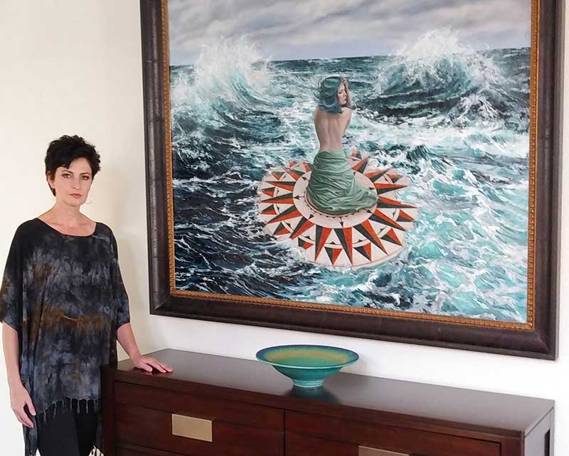 Katarzyna Kociomyk beside her painting, “Weathering the Storm” 48” x 60” Oil on Canvas