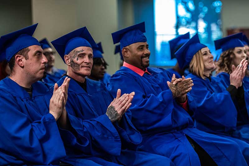 Graduates applaud all of the support for them during the graduation celebration held by Hope For Prisoners.