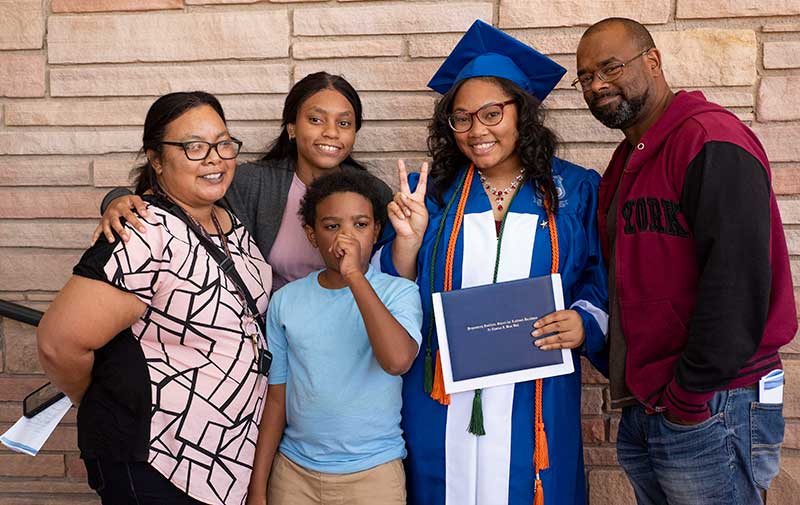 A family celebrates a student scholar success in graduating through the CORE program.