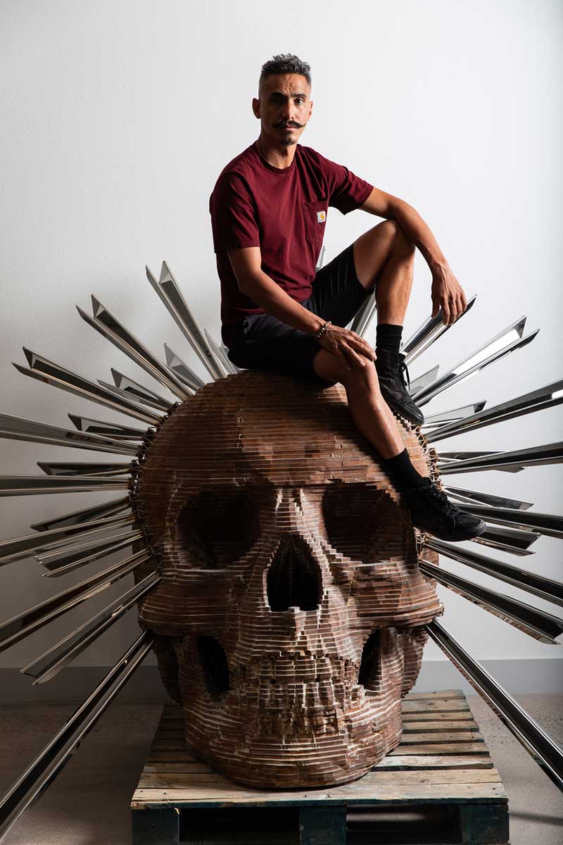 Luis Varela-RIco and his 5500 lb. metal skull sculpture, Peso Neto. Image by Krystal Ramirez