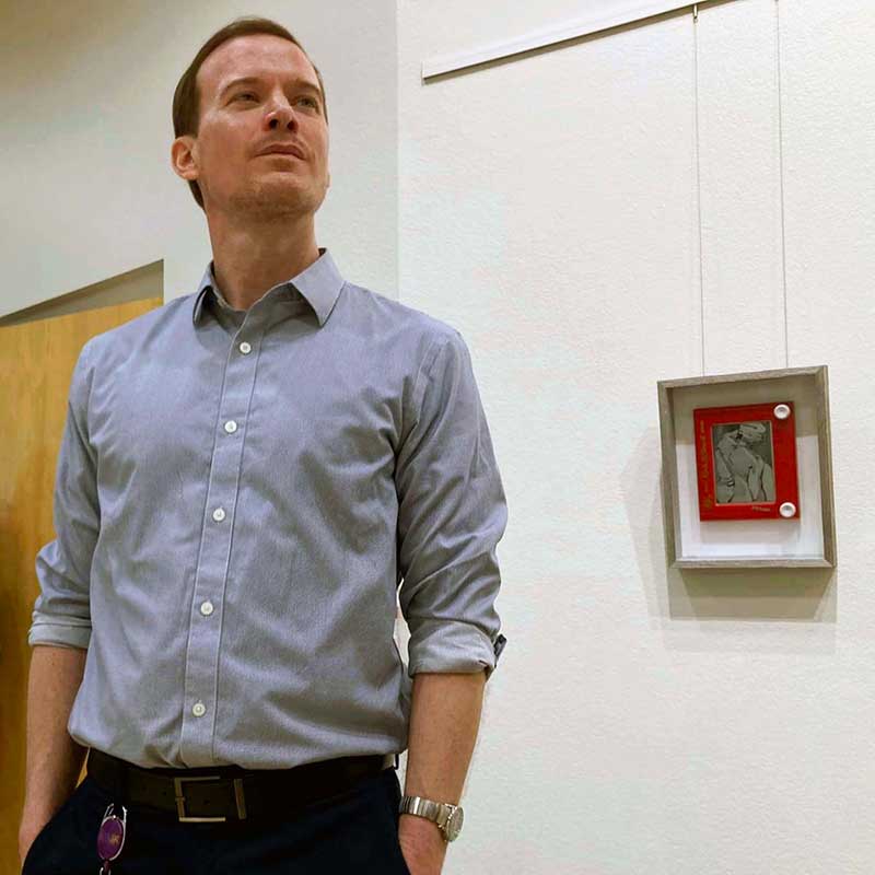 Darren Johnson at the "Unshakeable: Etch A Sketch Art Around The World, 1986-2024" exhibit at West Charleston Library. Photo by Drake Roberts