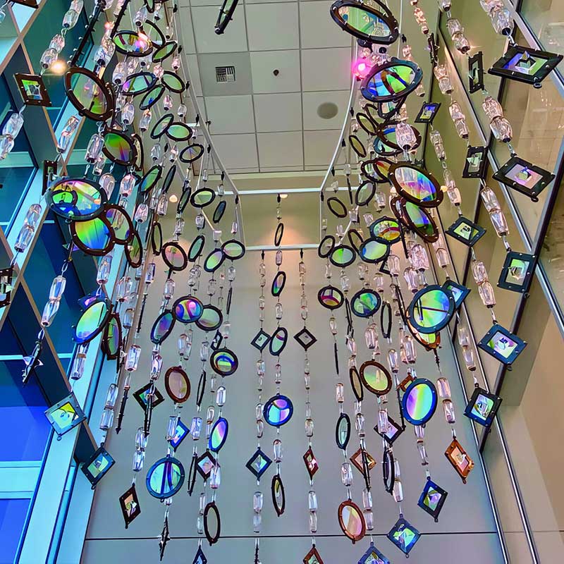 Detail view of suspended sculpture titled “Equal Justice for All” commissioned by City of Las Vegas for the Las Vegas Municipal Courthouse / overall size 24’ x 17’ x 12’ created from blown glass, dichroic glass, metal and crystal prisms