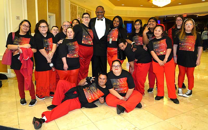 Peter Whittingham, chair of the board of directors of the Down Syndrome Organization of Southern Nevada, with the DSOSN Dance Troupe at the Festival of Trees and Lights gala at the Westgate Las Vegas Resort & Casino on Nov. 12, 2024 