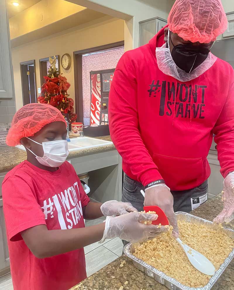 J-Haleem-004 J Haleem and his son JJ continuing annual holiday tradition by volunteering at the Ronald McDonald House