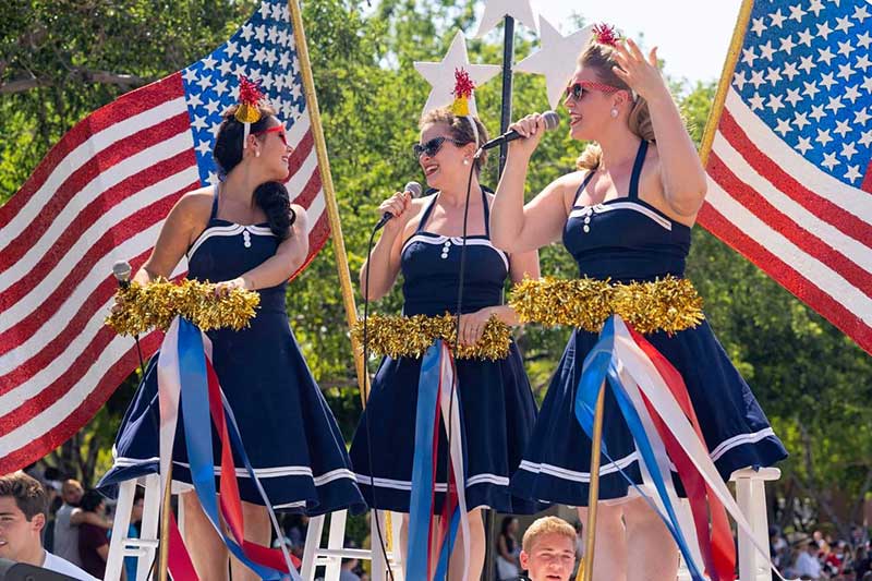 Lisa Quibell Harvey, Brittany Avey and Erin Britt sparkle onboard a float at Summerlin's Patriotic Parade. Photo courtesy of Summerlin Council