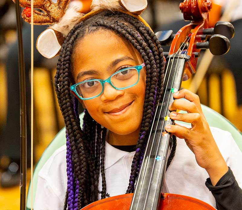 Cellist Riley Hislop performs in style at the 2024 winter concert (Richard Brusky)