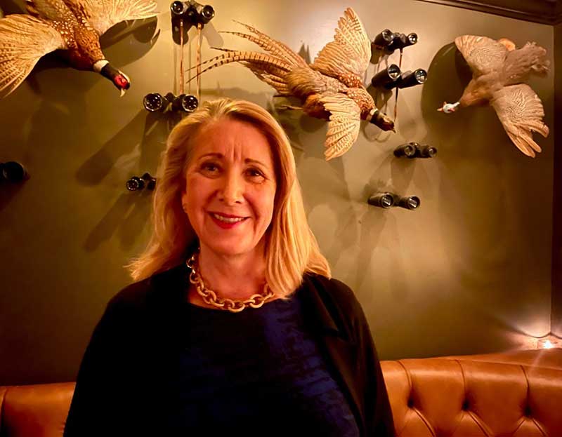 Oksana Komarnyckyj, Vice President of Wealth Management at Northern Trust Bank, an Alexis de Tocqueville Society member enjoying the ambiance and friends at The Doberman Drawing Room.