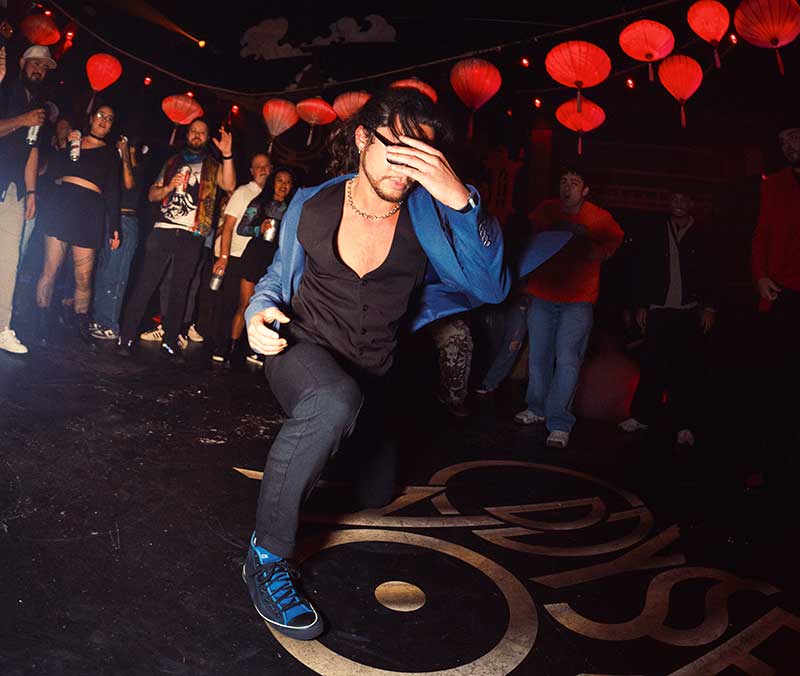 Photo of a freestyle dancer breaking away from the crowd at Oddyssey Noir by Daniel Auyon-Carillo