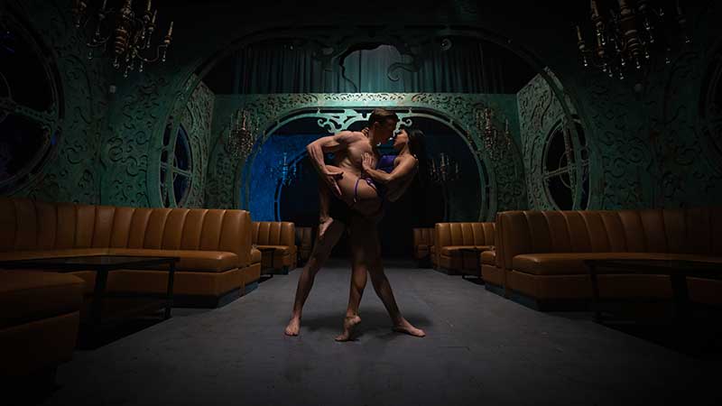 Holland Lohse and Sienna Martinez dance inside a lounge within Oddyssey Noir at AREA15 (Sean Jones)