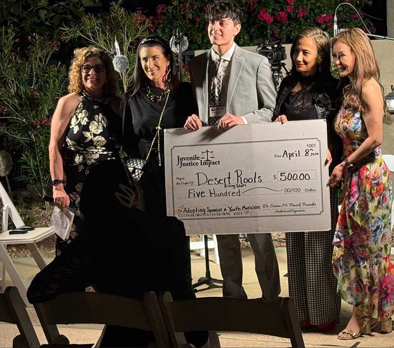 Dr. Susan Feneck, Li Jackson and Dr. Kate Zhong present a check to Shakeh Ghoukasian and recipient Damon Hernandez Jr.