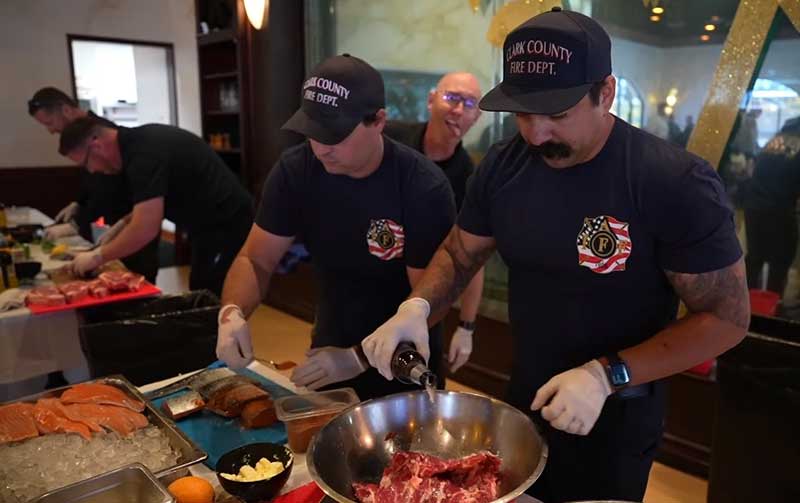 Team members of the Clark County Fire Department work together to create culinary delights Team members of the Clark County Fire Department work together to create culinary delights