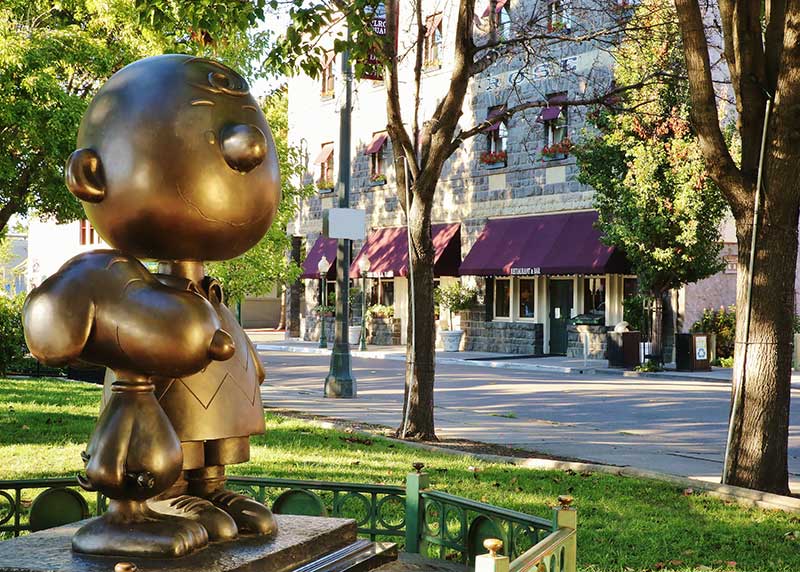 Bronze statues of Charlie Brown and Snoopy stand across from Grossman's Noshery & Bar in Historic Railroad Square (Photo courtesy of Visit Santa Rosa)