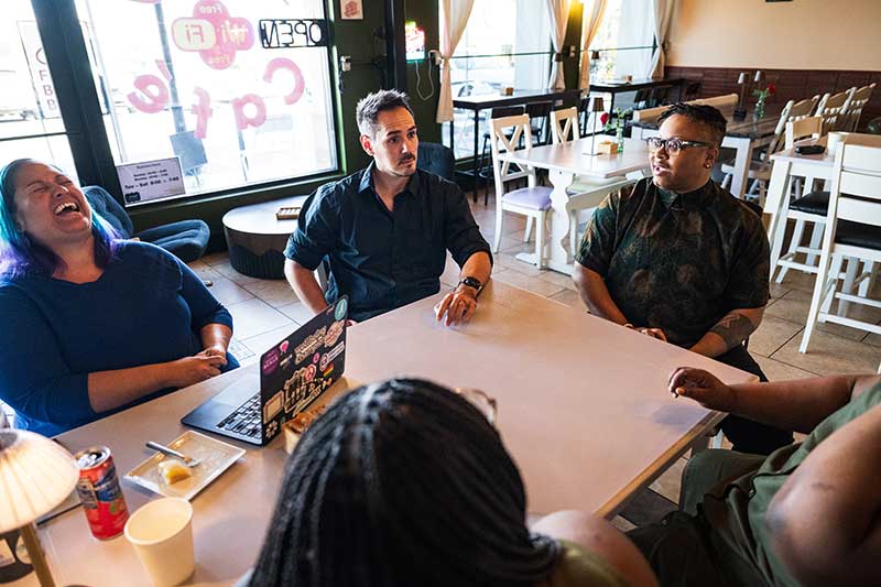 Ashlan Glazier-Anderson meeting with clients at a café