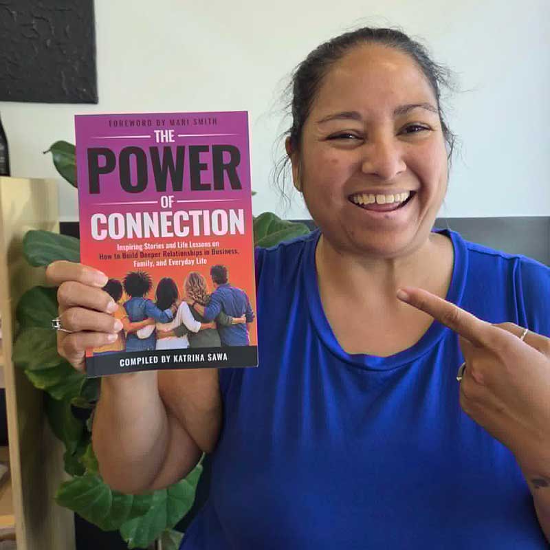 Ashlan Glazier-Anderson holds a copy of “The Power of Connection”